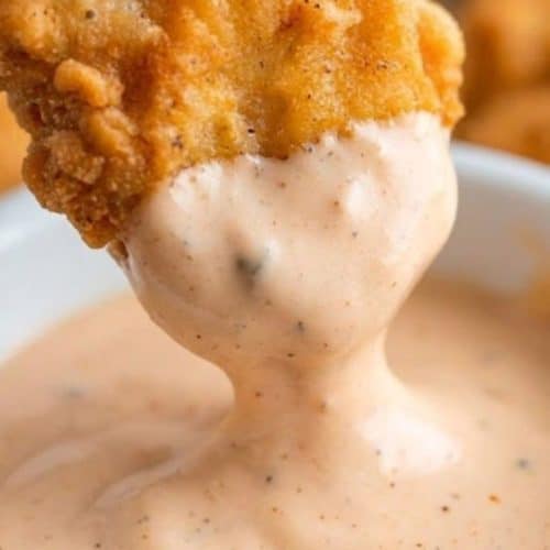 A plate of crispy homemade chicken nuggets with dipping sauce