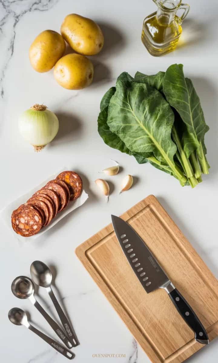ingredients for caldo verde—potatoes, onion, garlic, collard greens, chouriço, olive oil and kitchen tools