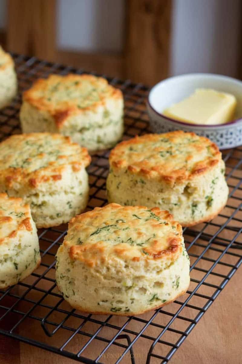 Golden savory cheese and herb scones on cooling rack