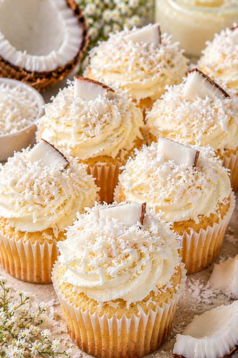 Soft and moist vanilla cupcakes topped with fluffy frosting and coconut flakes