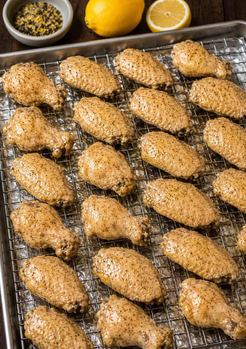 lemon pepper chicken wings marinated and ready to bake on a baking tray