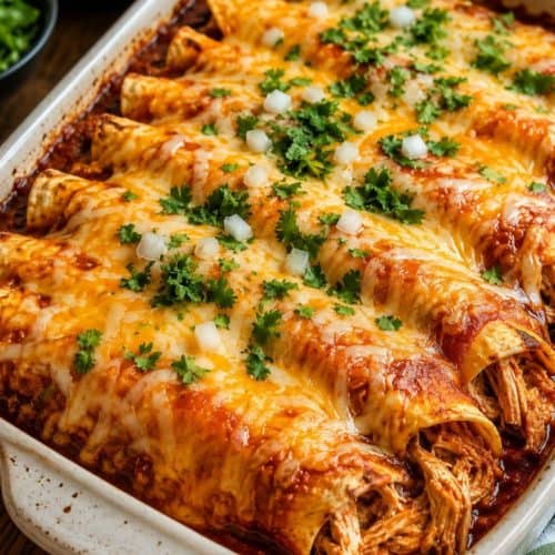 chicken enchiladas in a white baking dish