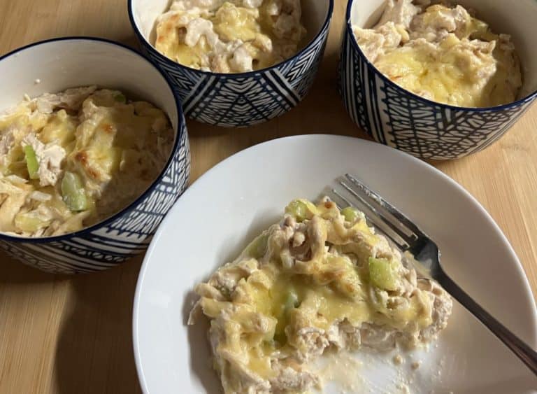 serve of high protein buffalo chicken bake on a white plate three bowls of buffalo chicken