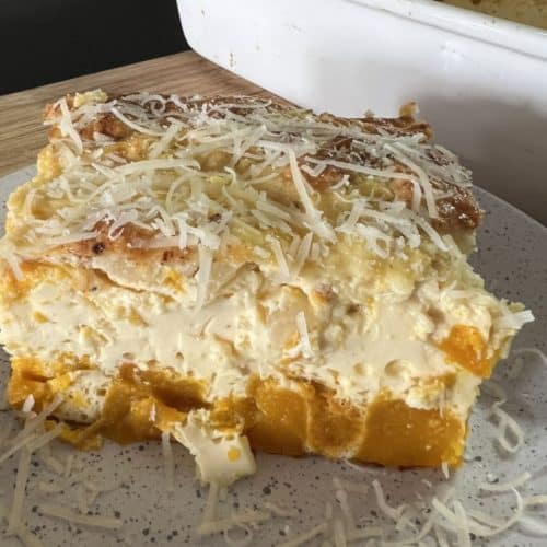 slice of kobocha squash frittata on white plate baking dish with Kobocha frittata