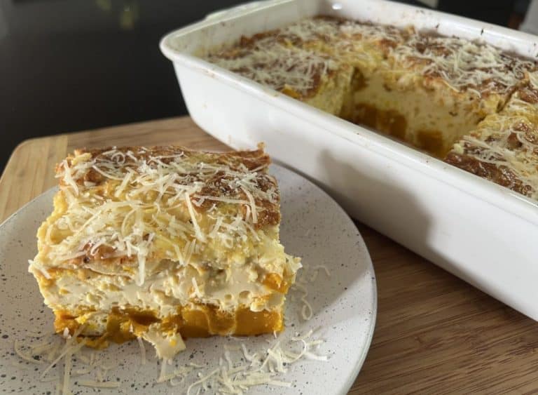 slice of kobocha squash frittata on white plate baking dish with Kobocha frittata