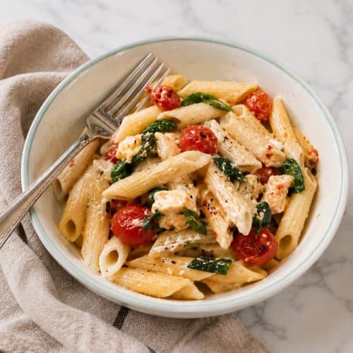 baked feta pasta with cherry tomatoes and spinach